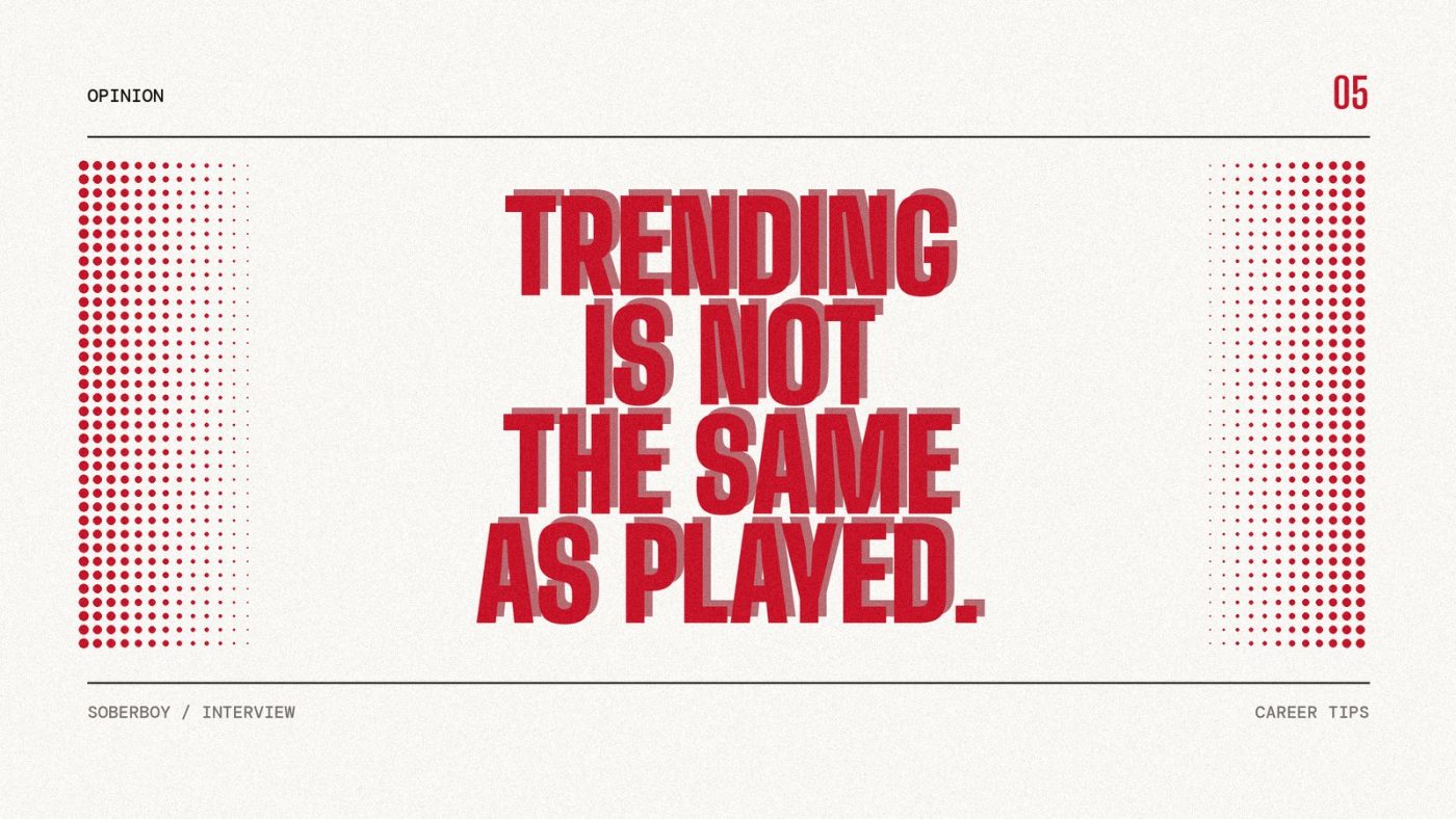 Screen-print poster reading "Trending is not the same as played." in heavy red condensed type on paper.