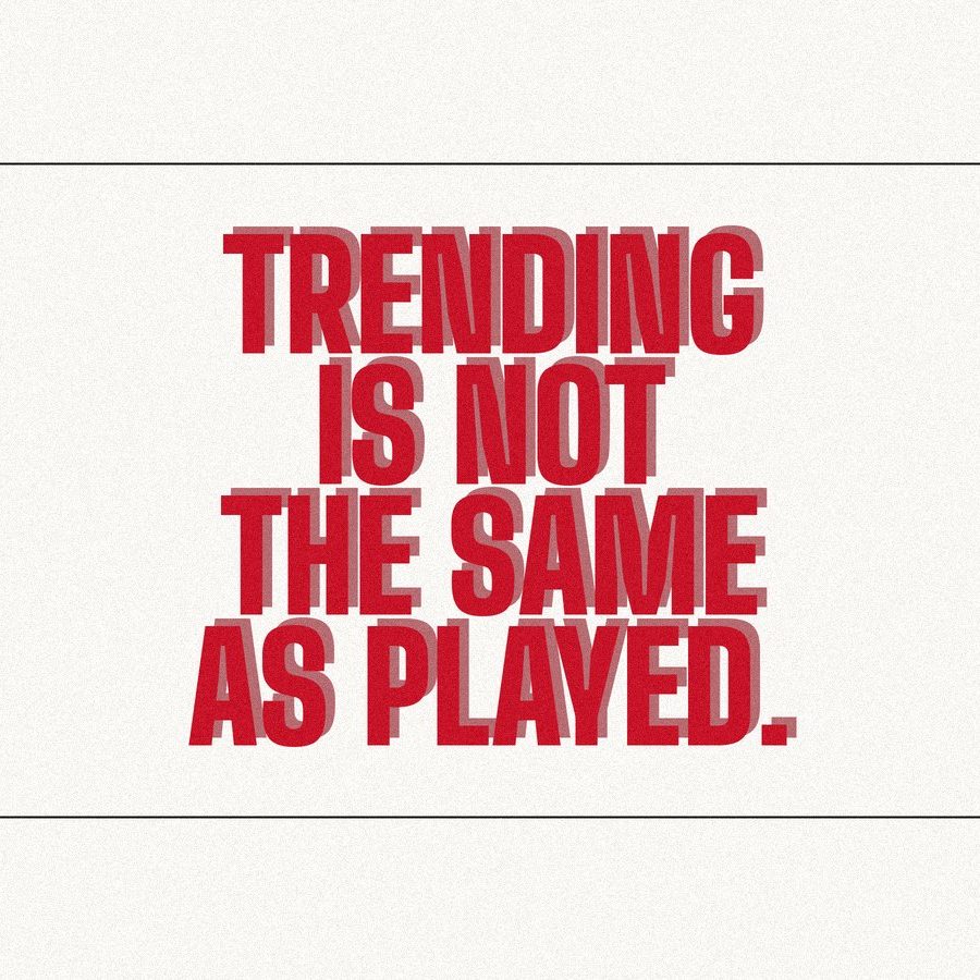 Screen-print poster reading "Trending is not the same as played." in heavy red condensed type on paper.
