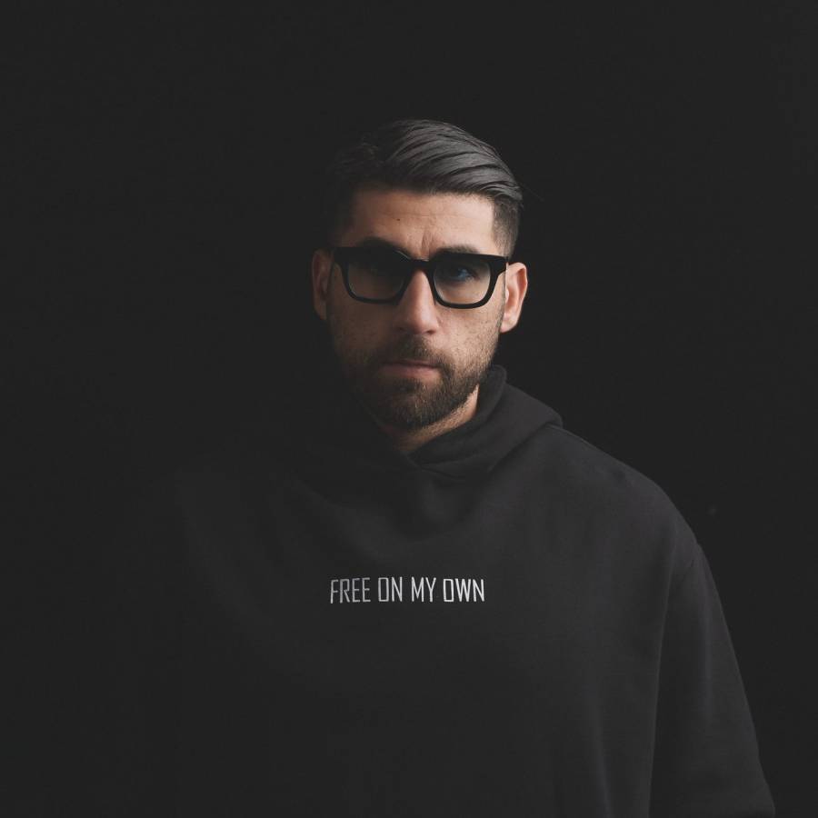 Soberboy, photographed against a black background in a hooded sweatshirt reading Free On My Own